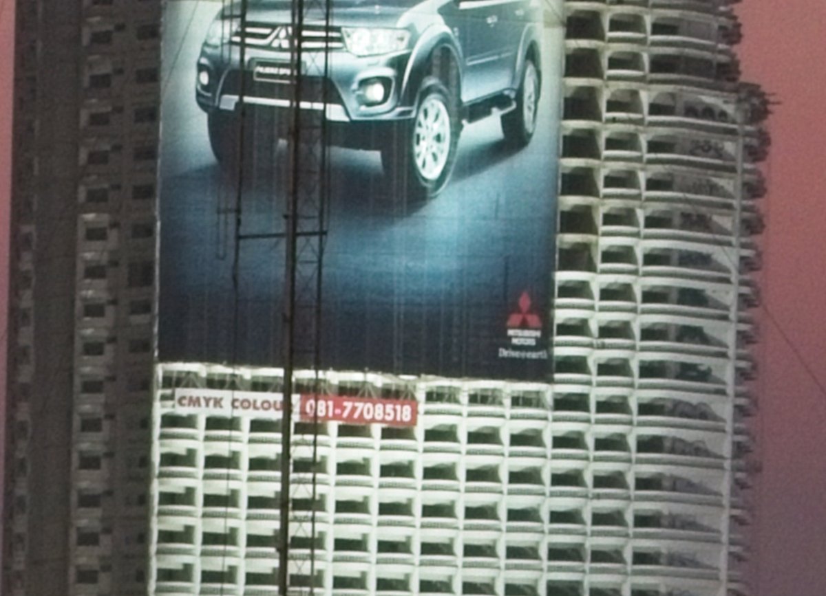 Zoomed-in image of a building with a billboard