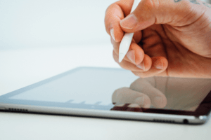 Stock image of a person using a stylus on an iPad