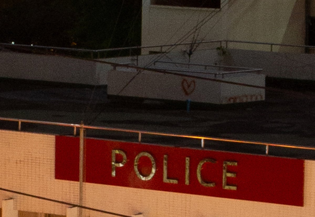 Unedited image of rooftop and police sign in Lightroom
