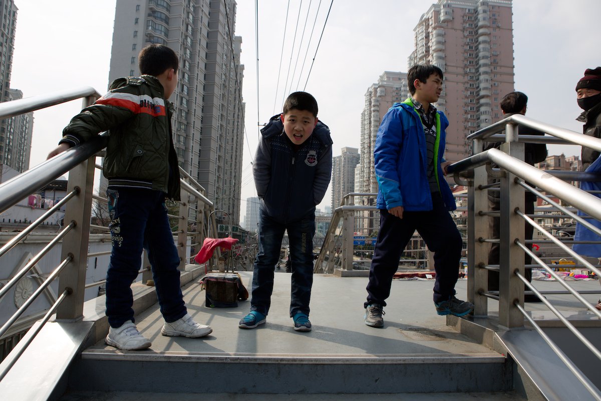 RAW image of kids standing on a city platform