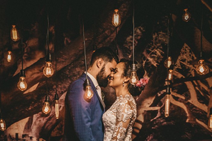 Wedding photo of couple with hanging decorative lights