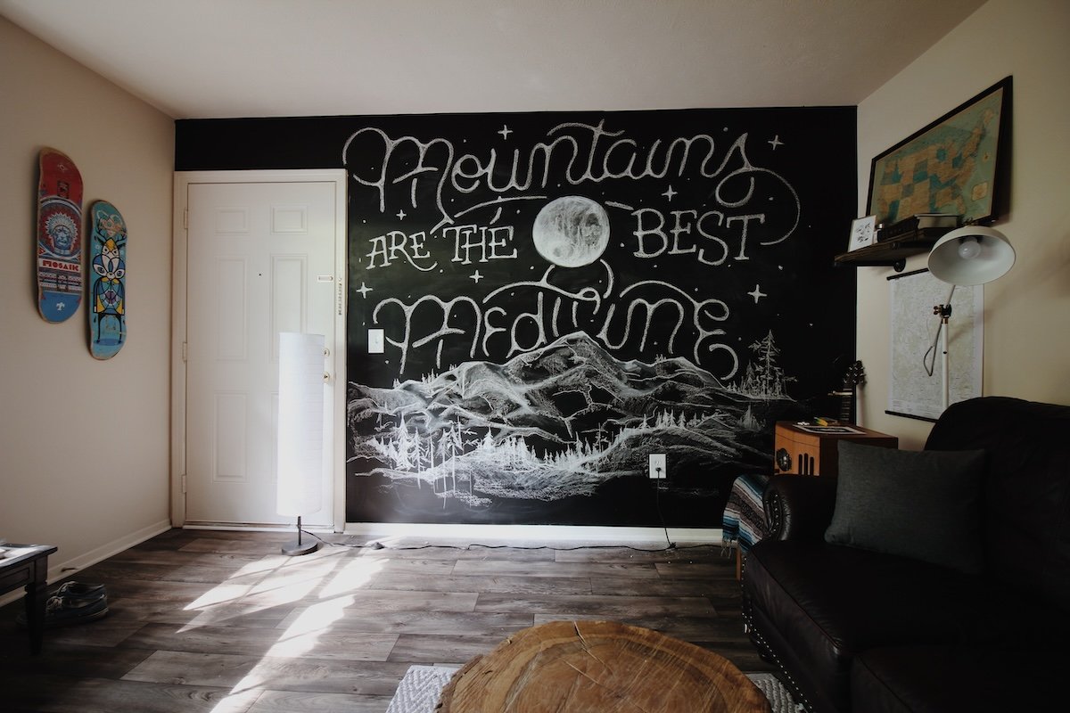 Chalk background with words and a mountain landscape as a DIY photography prop