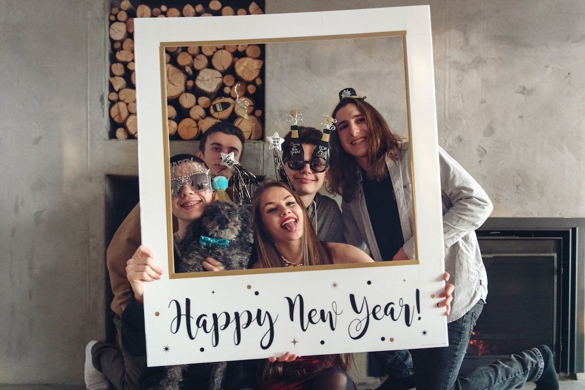 People using a New Year's DIY photography props frame