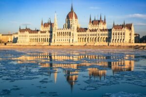 The Hungarian Parliament building in Budapest with its reflection in the frozen Danube river shot with a deep depth of field