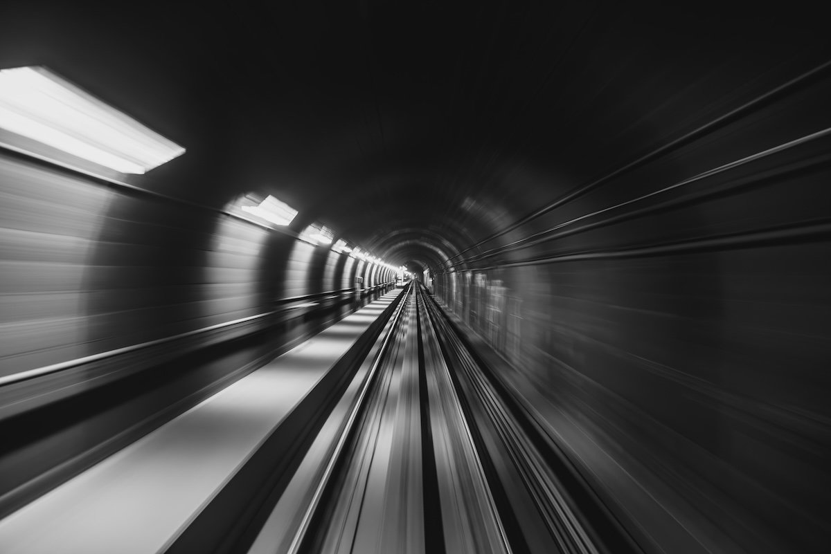 An underground train tunnel shot in black and white and with motion blur