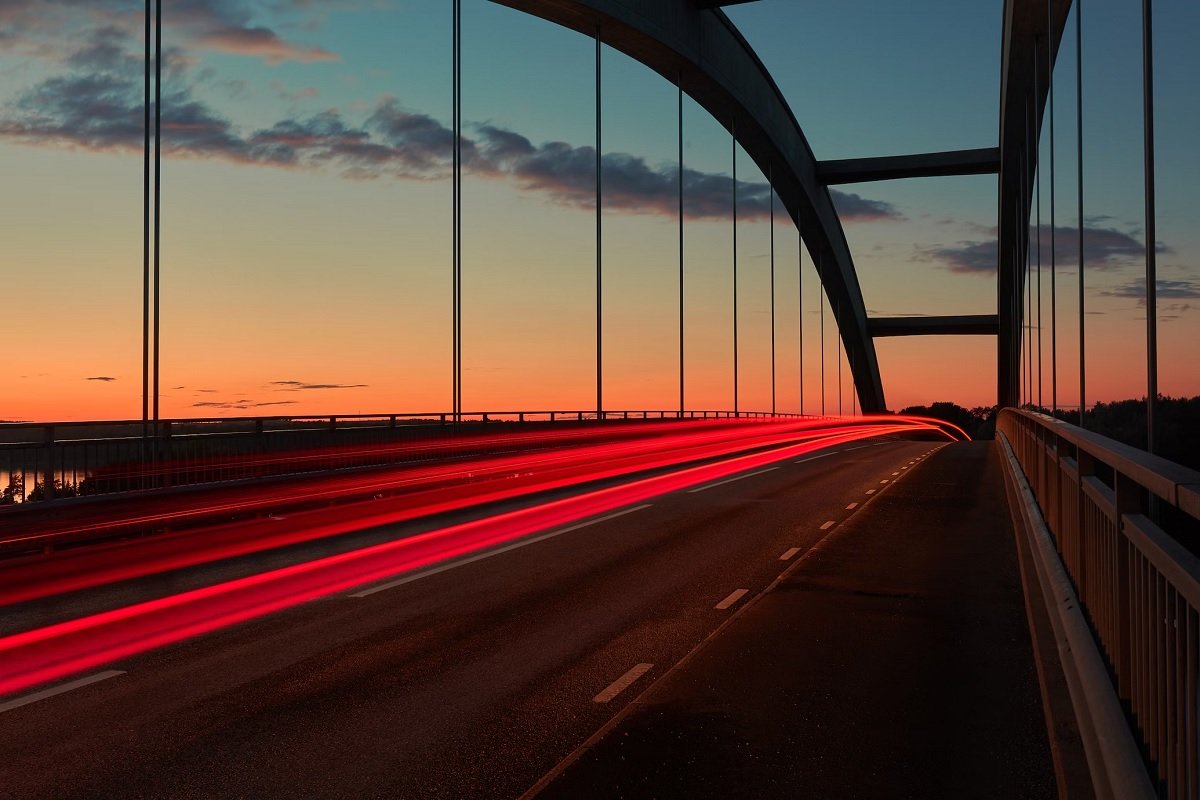 Image of car lights across a bridge at dusk using the best lens for long-exposure photography