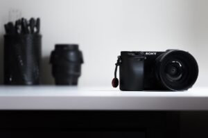 Sony a6000 camera on a white table with lenses in the background