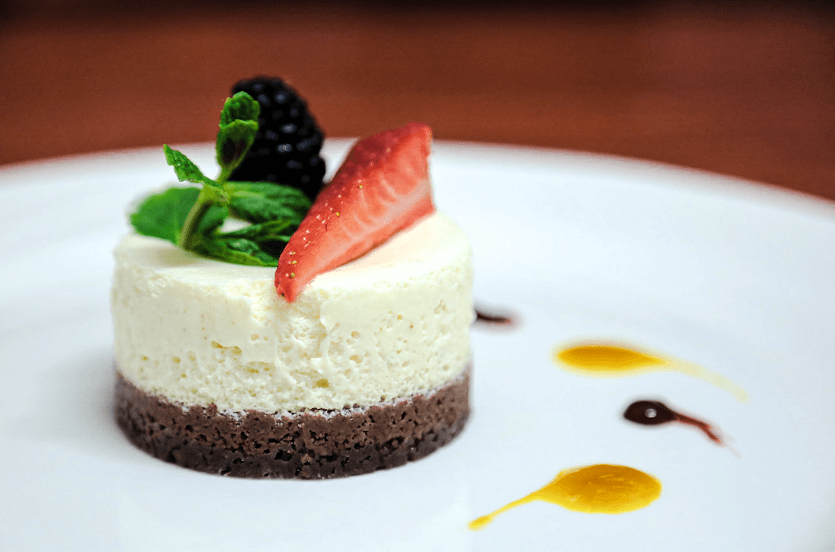 An artistic photo of an individual cheesecake on a plate