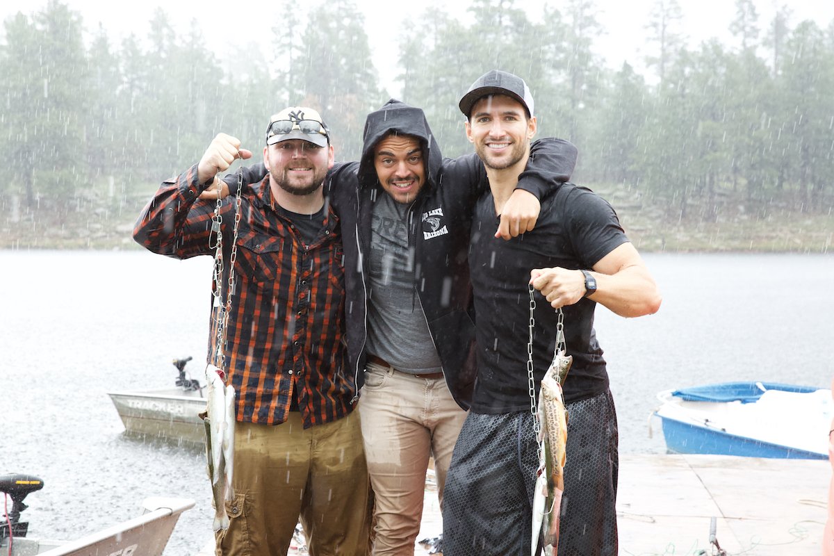 photograph of three men in the rain after a fishing trip