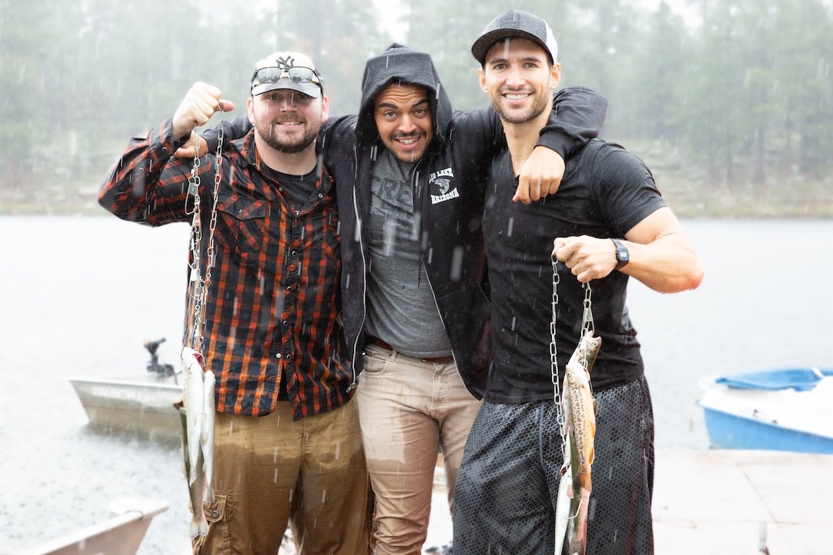 image of three men going fishing on a rainy day with an edited blurred background