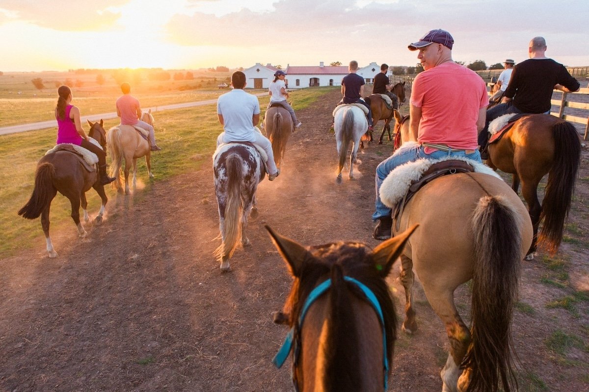 photo of a group of people riding horses