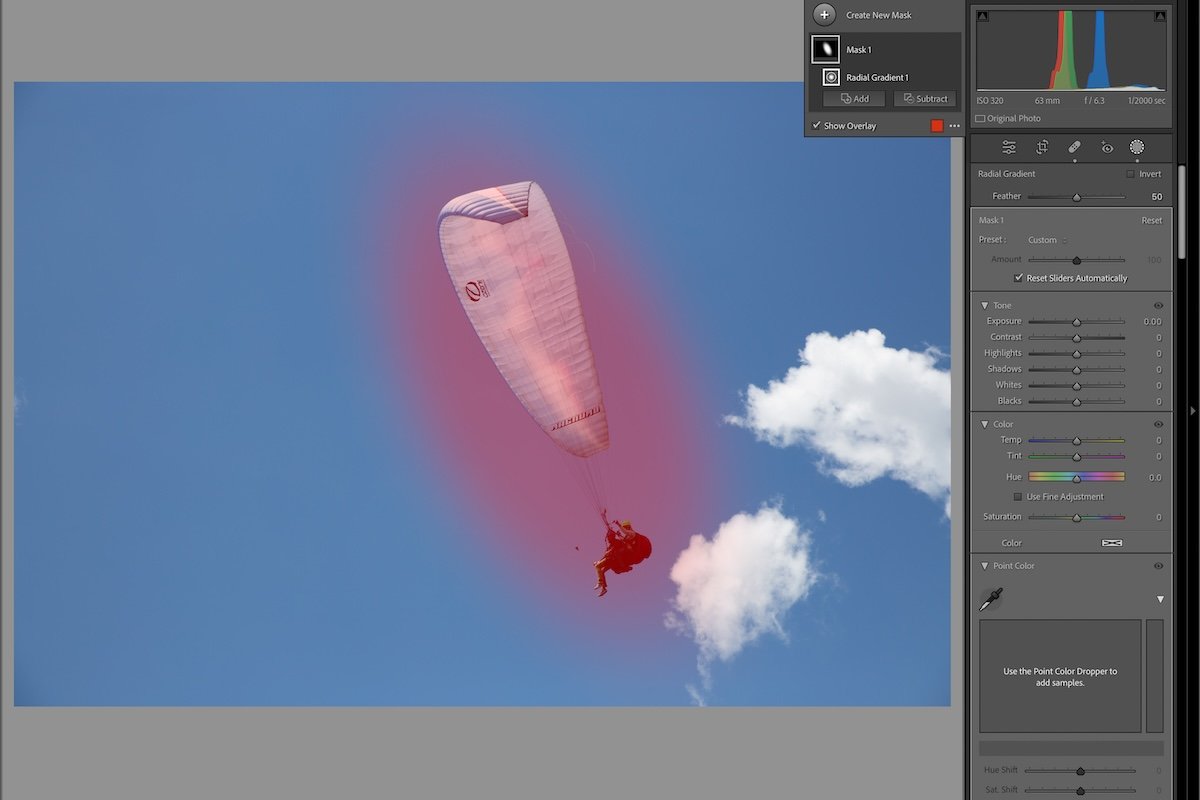 photograph of a paraglider in the air with a radial gradient in lightroom