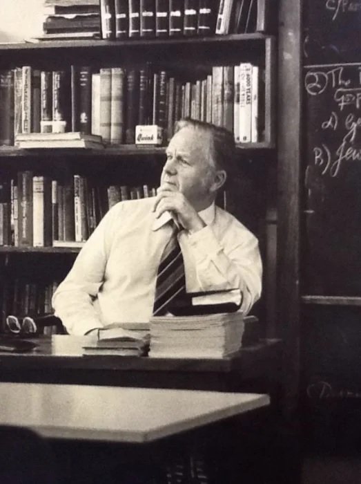 Candid portrait or a man in shirt and tie sitting at a desk