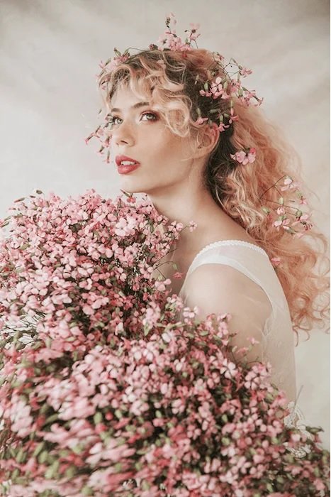 Portrait of a woman with lots of pink flowers