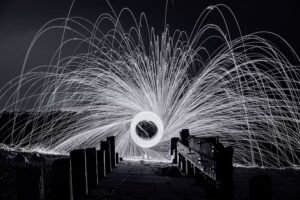 Black-and-white image of someone spinning sparkler for creative lighting ideas