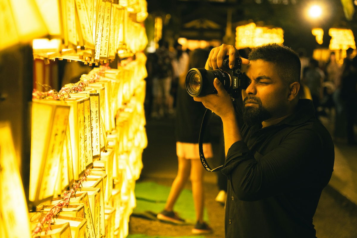 man photographing lights at night