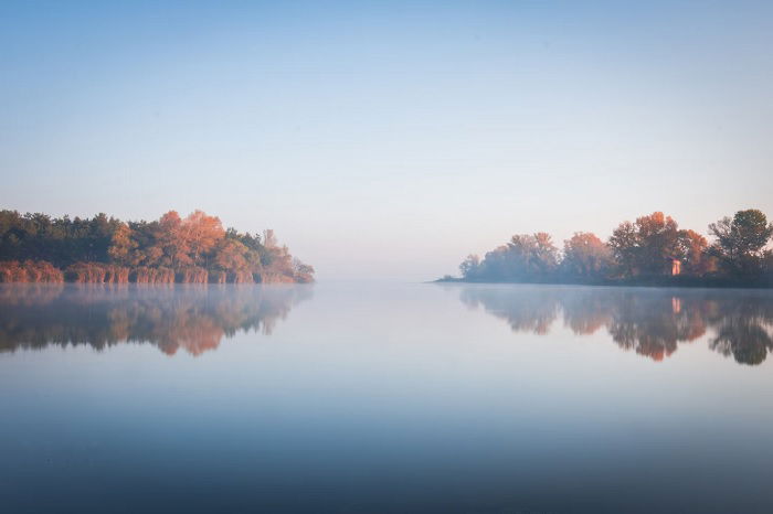 Landscape of a lake with trees on either side