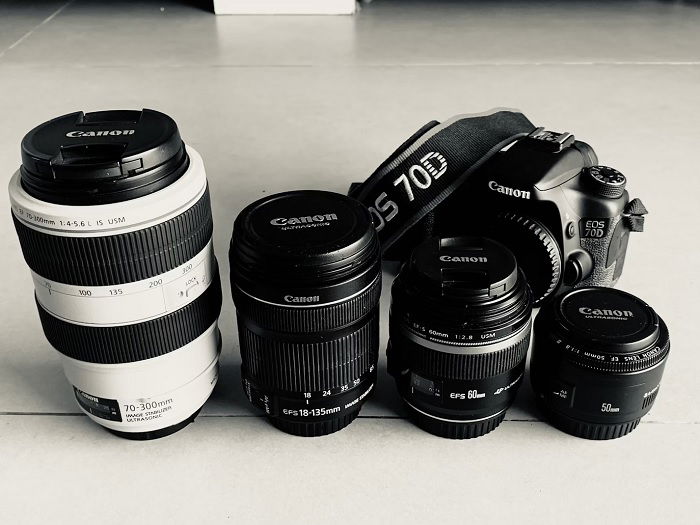 Four Canon EF lenses next to a Canon 70D camera