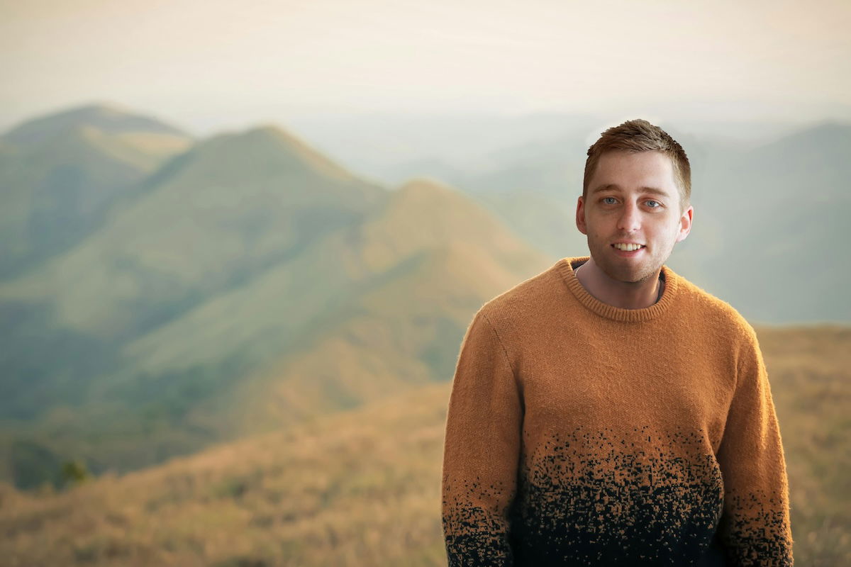 photoshop image of a face swap with man on a mountain