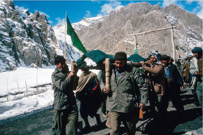 Men marching on mountain road