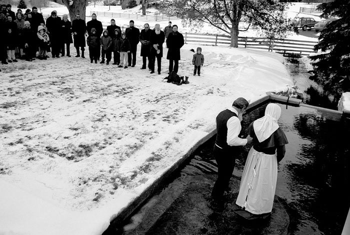 Outdoor baptism in sown with crowd watching