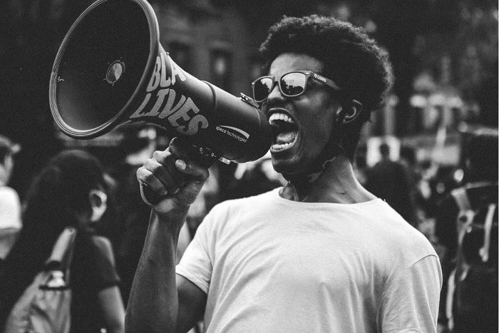 Man yelling through a loudspeaker