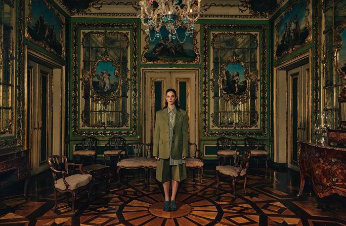 Woman standing in a palatial room