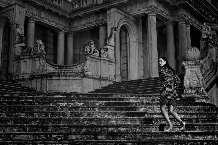 Woman climbing palace stairs