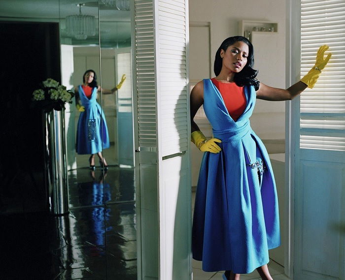 Woman in blue dress and yellow rubber gloves