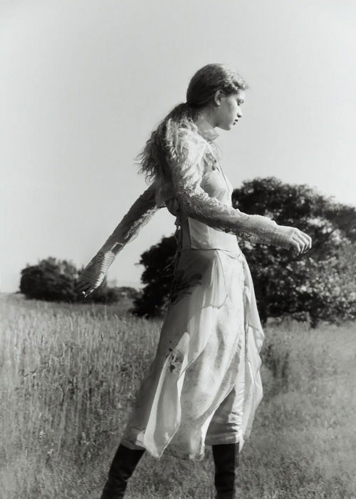 Young woman strolling through a meadow