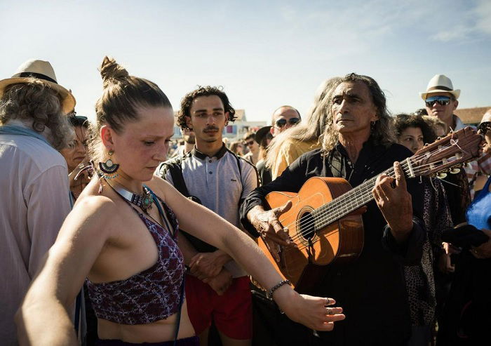 Guitarist and dancer standing in a crowd