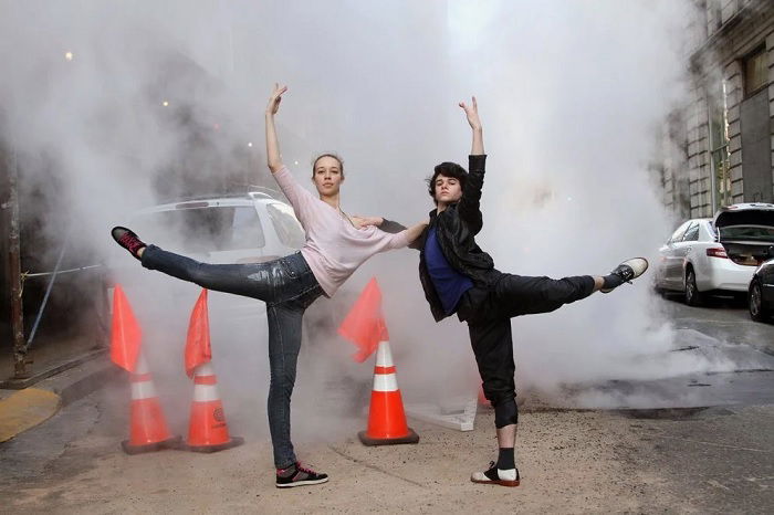 Two dancers posing in a steamy New York street