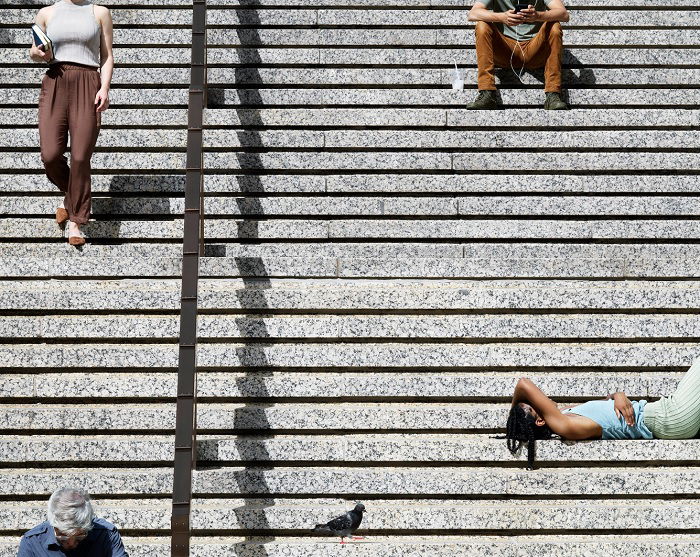 Four people on street stairs