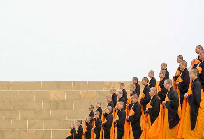 Monks lined up in ceremonial dress