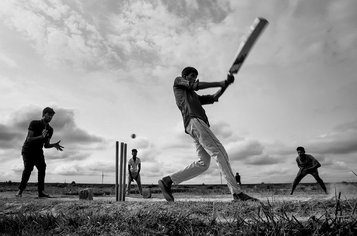 Low angle shot of people playing cricket