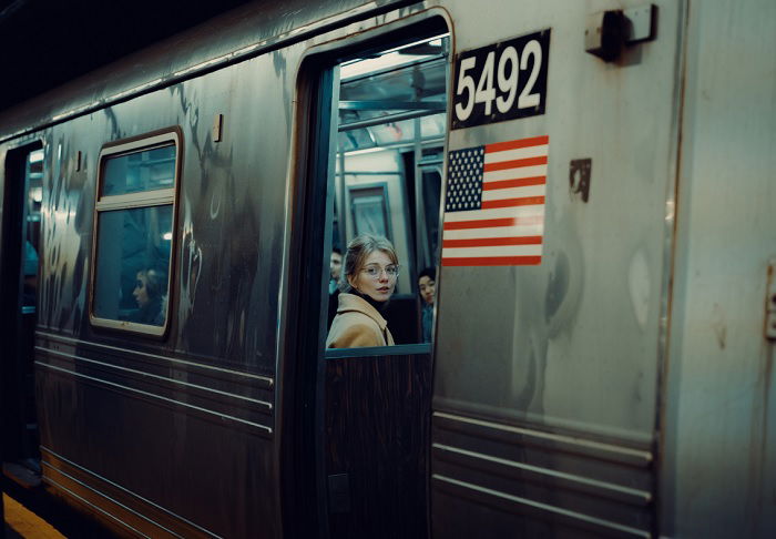 Woman seen through the door of a subway train