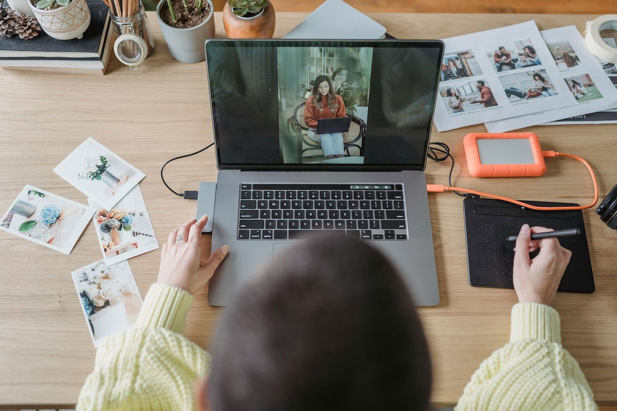 photographer working at laptop editing photos