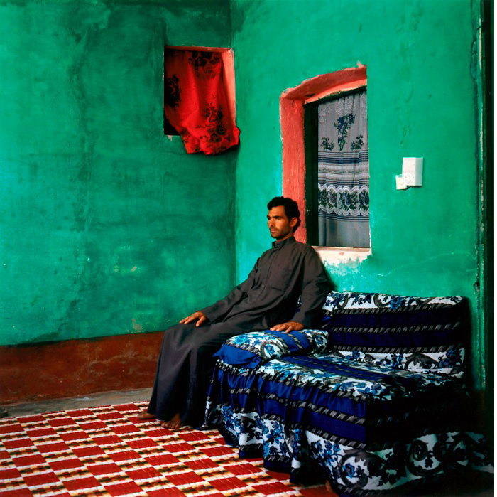 Man sitting on sofa in colorful room