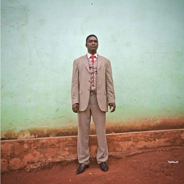 Man in suit against a blue wall