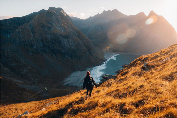 Person walking on mountainside in the evening