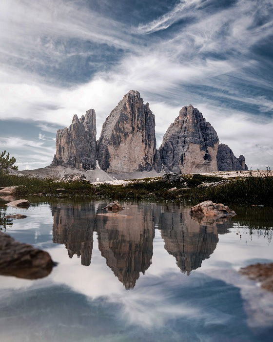 Three rocky peaks beyond a lake