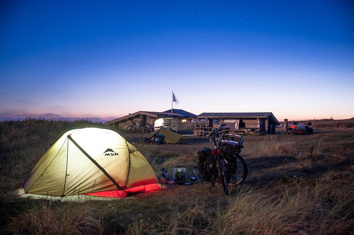 Bike and tent on cold grassy plane