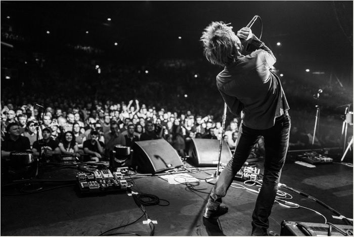 Singer leaning back on stage