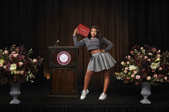 Megan Thee Stallion next to a lectern