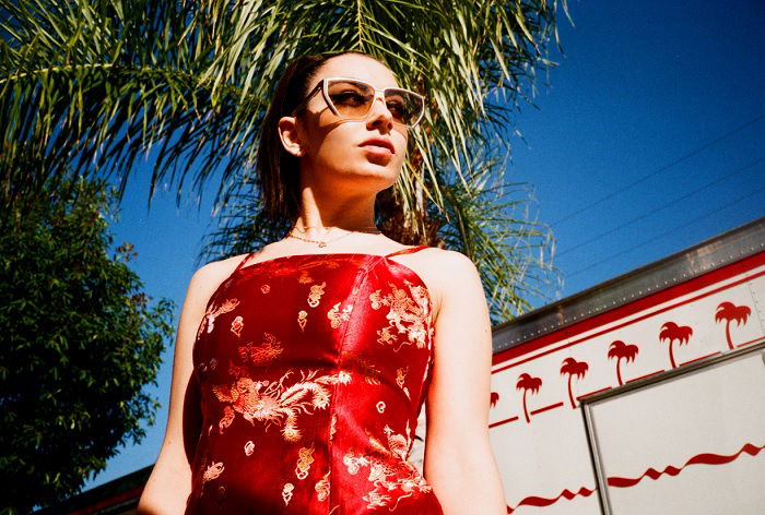 Outdoor, low-angle portrait of Charli XCX