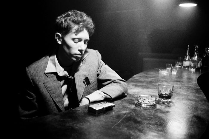 black and white portrait of King Krule in a bar