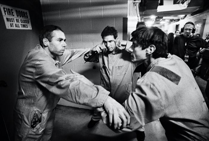 Beastie Boys in a huddle backstage