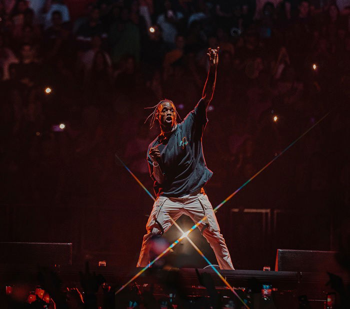 Man raising his arm while performing on stage