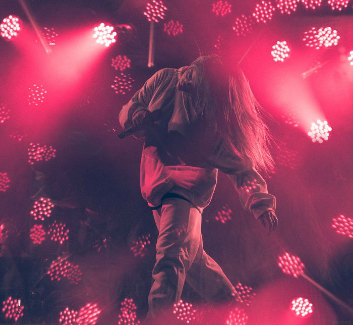 Female performer bathed in pink light