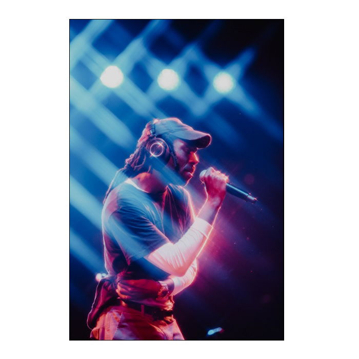 Blood Orange singing beneath blue lights